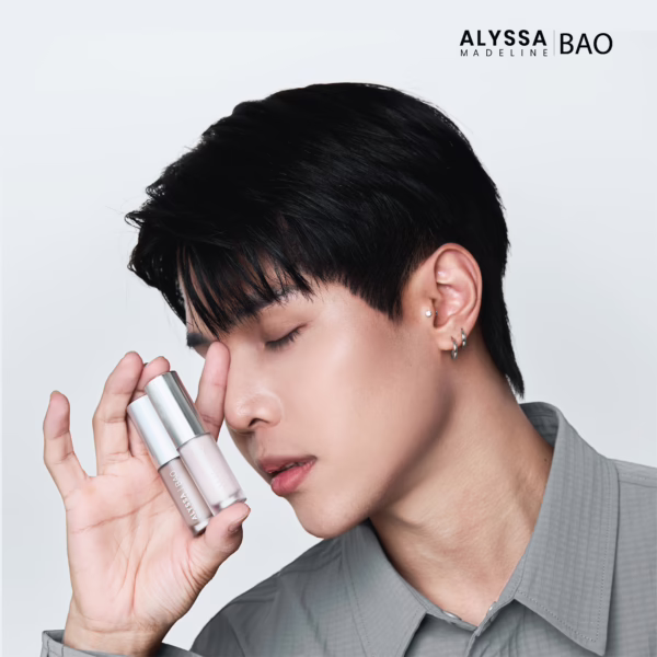 Person showcasing skincare product, eyes closed.